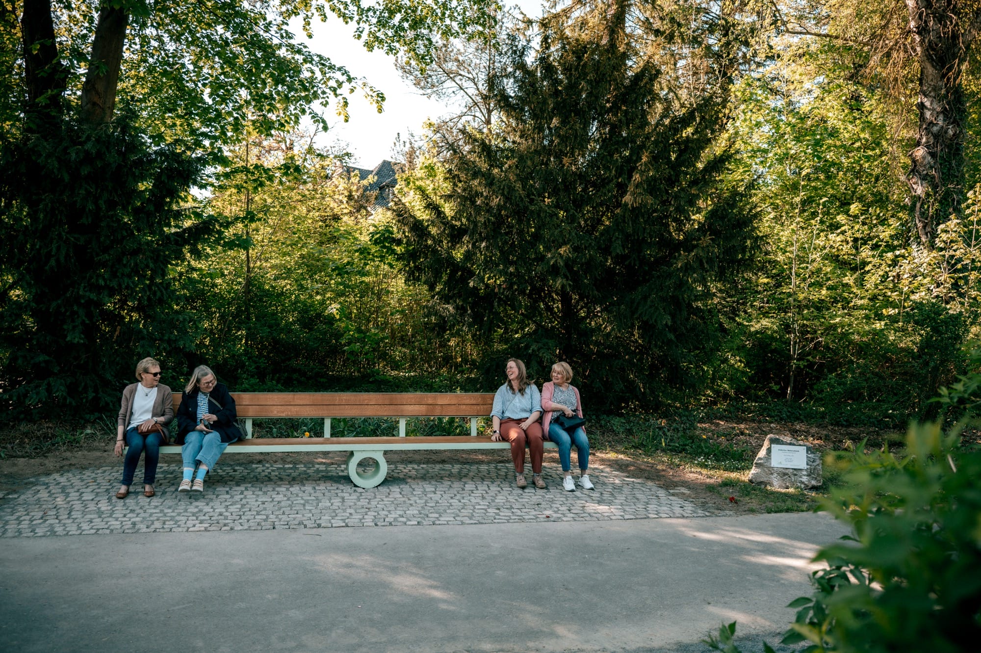 a bench sits perfectly flat as people balance on either side